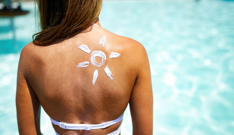 sunscreen on girl at beach bikini